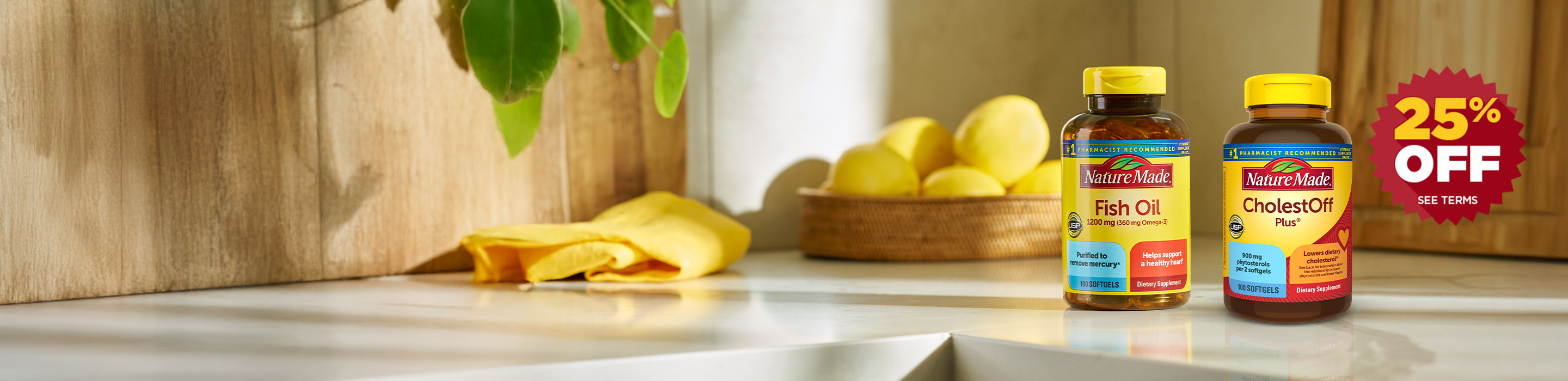 Nature Made vitamins and supplements on a kitchen counter with lemons in the background featuring Fish Oil and CholestOff bottles with a 25% off offer.