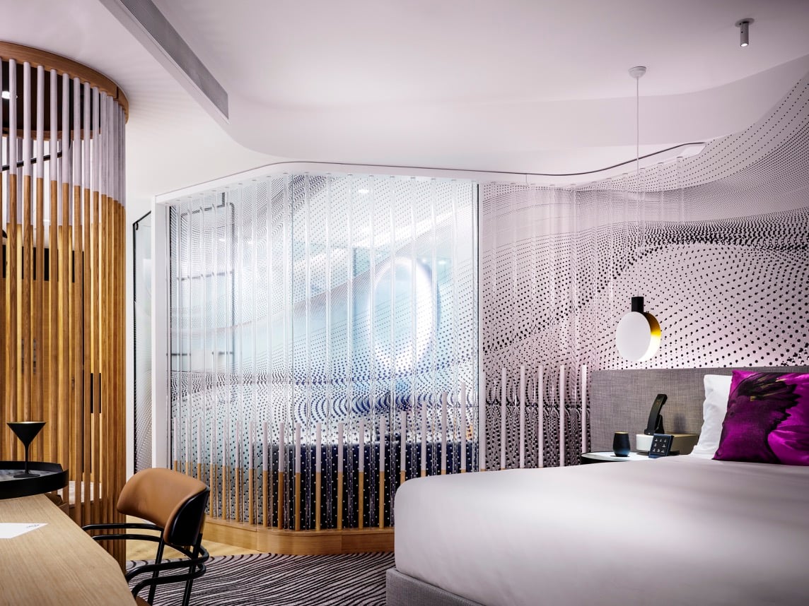 The W Hotel Brisbane layers materials and colour, creating interesting and unexpected spaces within each hotel suite, including the circular timber wardrobes and open plan bathing areas. Photos © Justin Alexander.