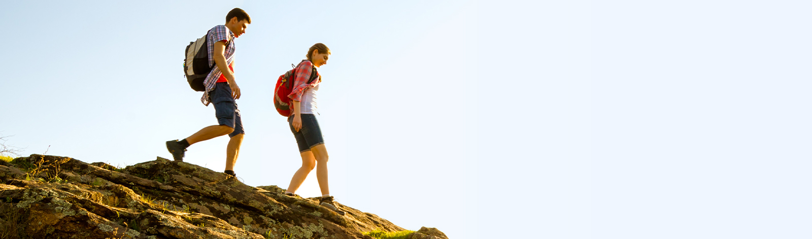 Happy couple hiking with backpacks