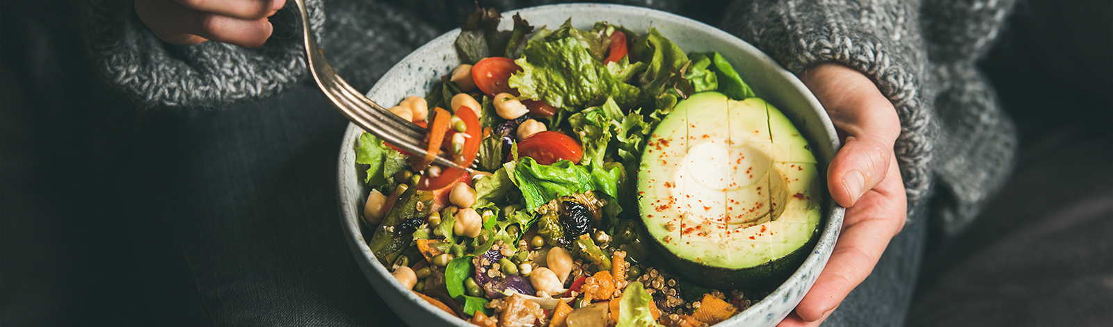 Woman eating a healthy salad bowl