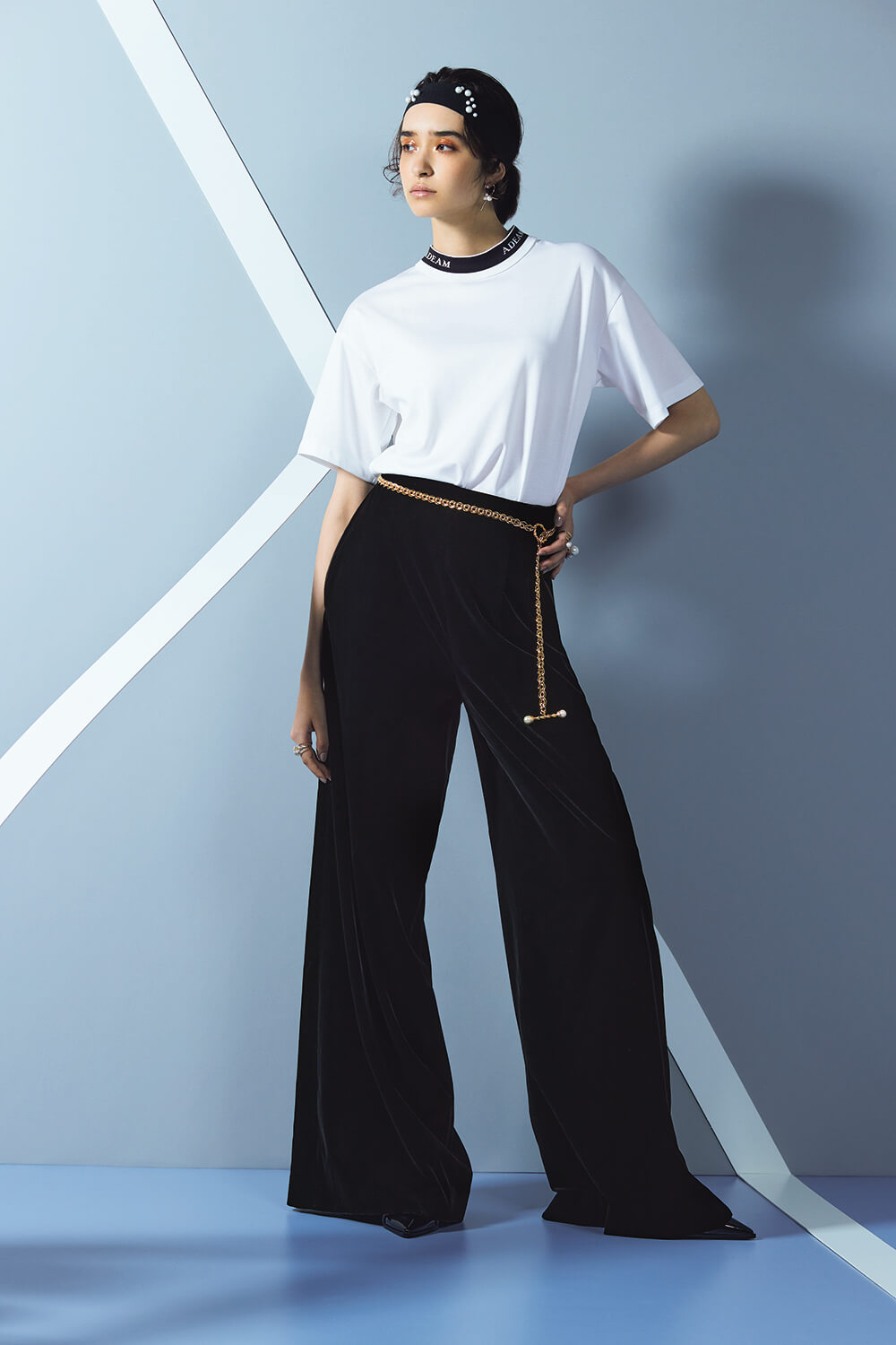 model in white tee and black wide leg pants