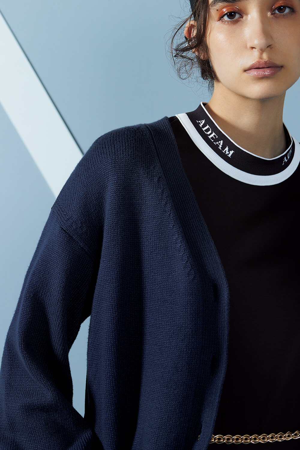 close up of model in navy adeam knit top