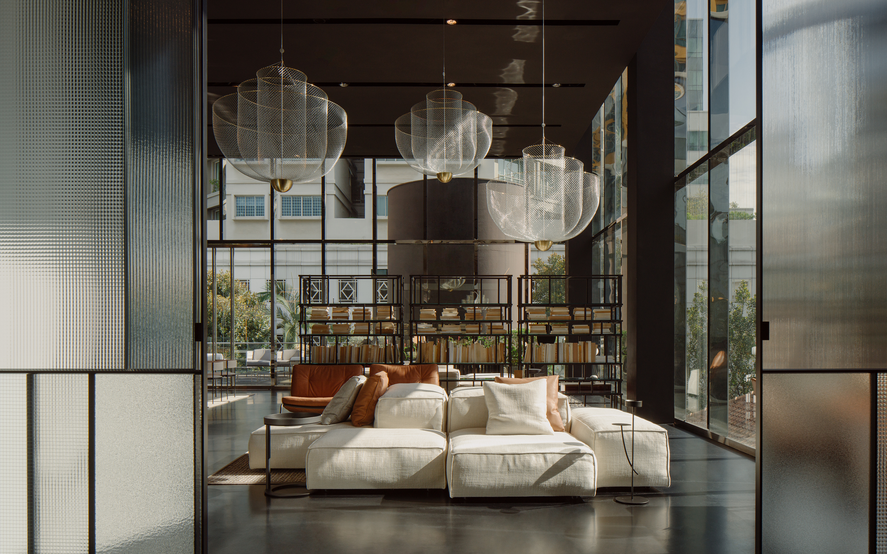 The Sherazade sliding door designed by Piero Lissoni for Glas Italia, the Extrasoft sofa designed by Piero Lissoni and the Off Cut shelving system by Nathan Yong for Living Divani, with the Meshmatics chandelier designed by Rick Tegelaar for Moooi. Image © Khoo Guo Jie, Khoogj.