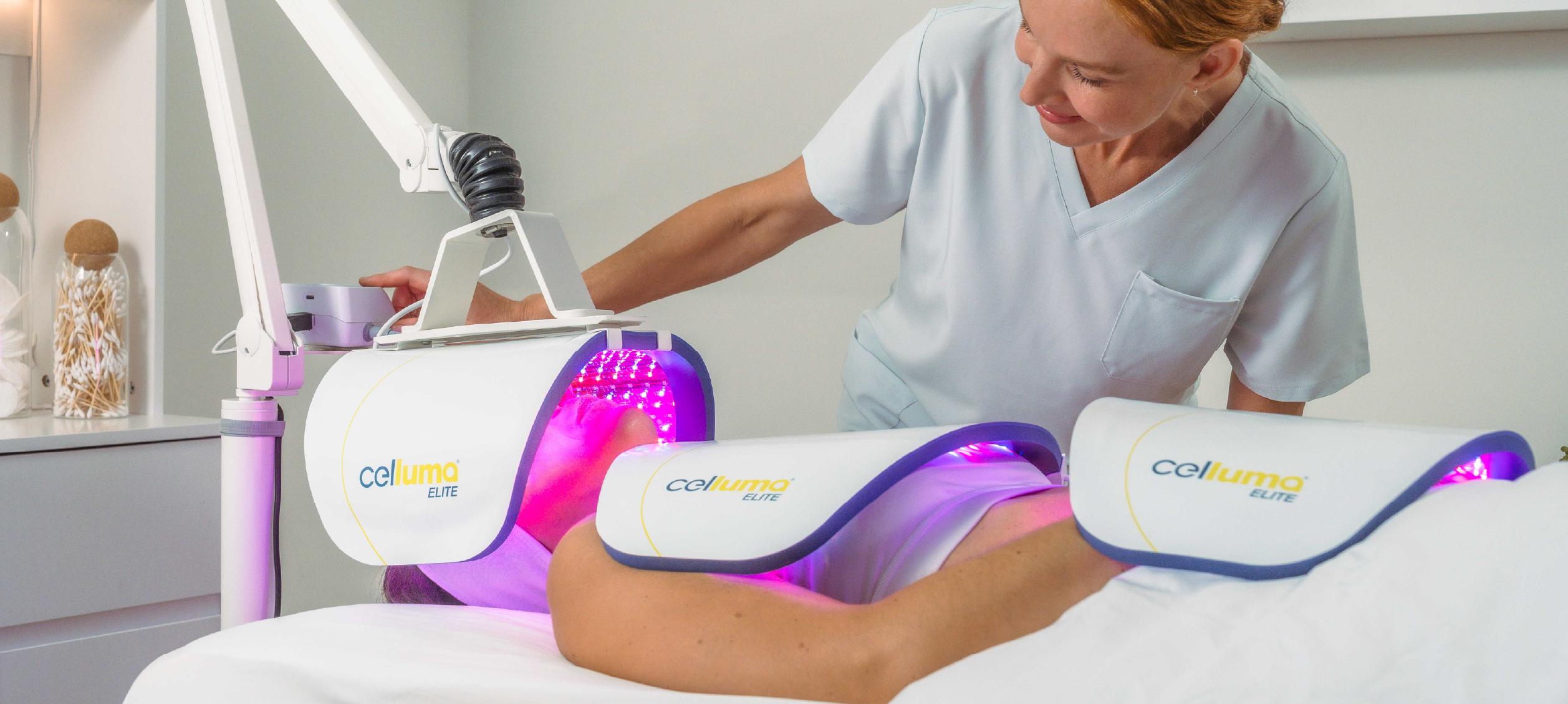 A clinical practitioner providing a skin rejuvenation treatment to a client with a Celluma ELITE LED Light Therapy System 