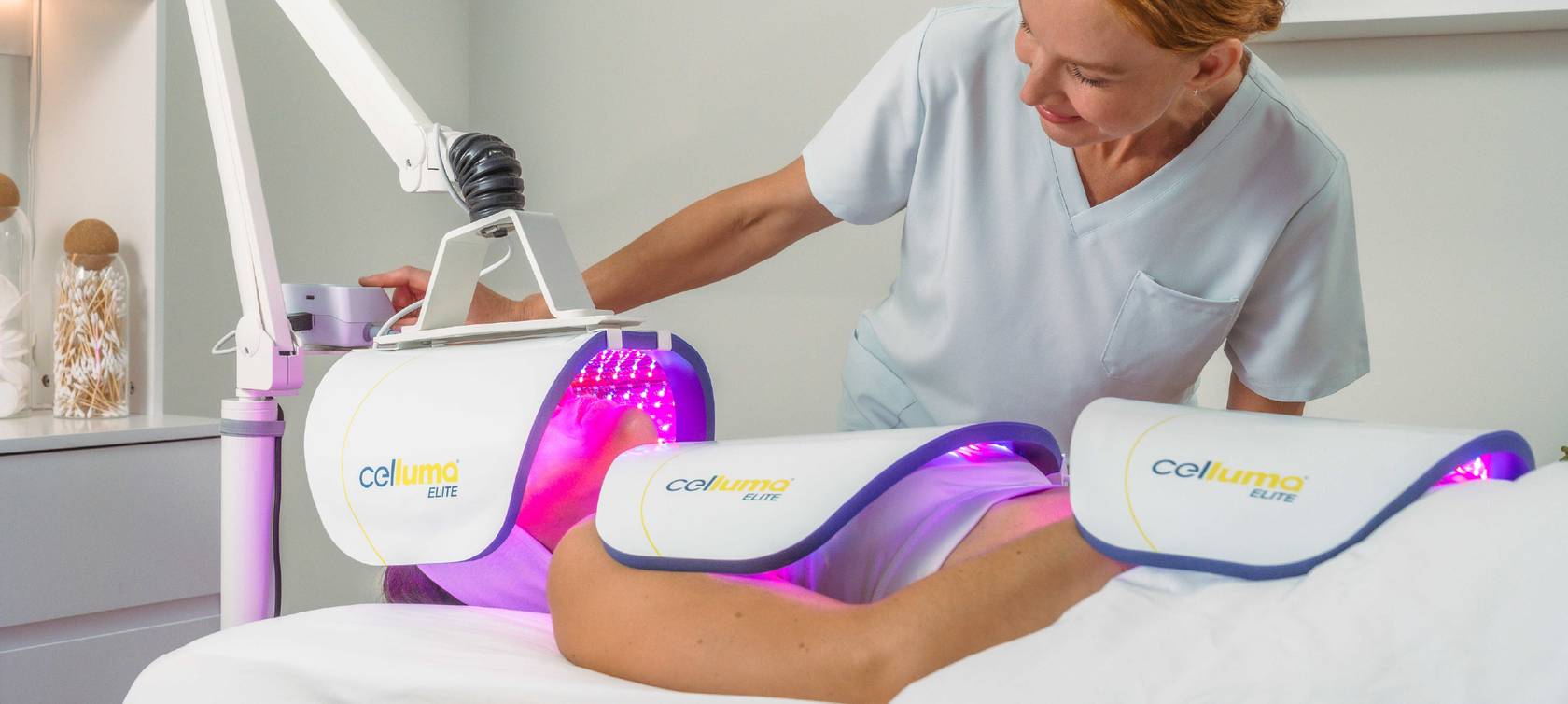 A clinical practitioner providing a skin rejuvenation treatment to a client with a Celluma ELITE LED Light Therapy System