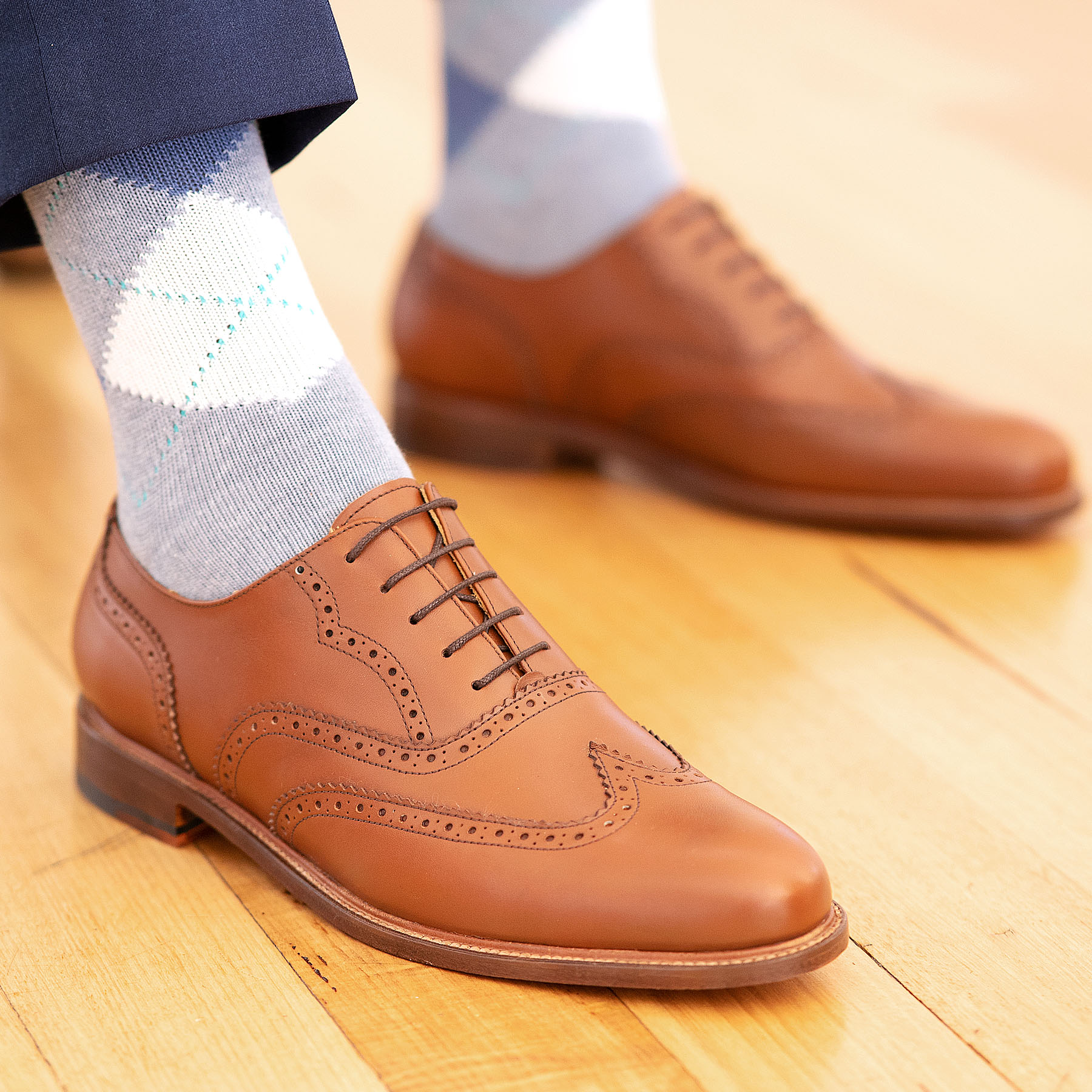 A pair of leather Oxford full brogue shoes, Simba in tan, paired with mixed of navy blue and white cotton socks