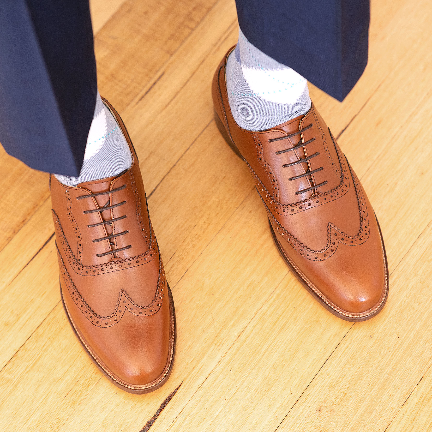 The Simba oxford full brogue leather shoes with beautiful with decorated brogues, worn with dress pants and stripped shirt
