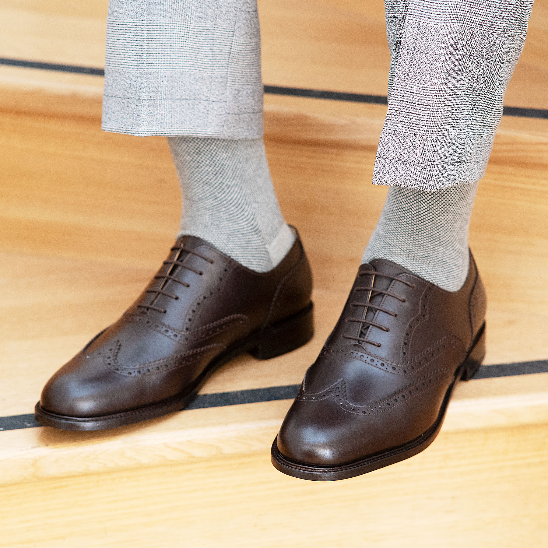A pair of Oxford full brogue leather shoes in espresso paired with 100% grey cotton socks.