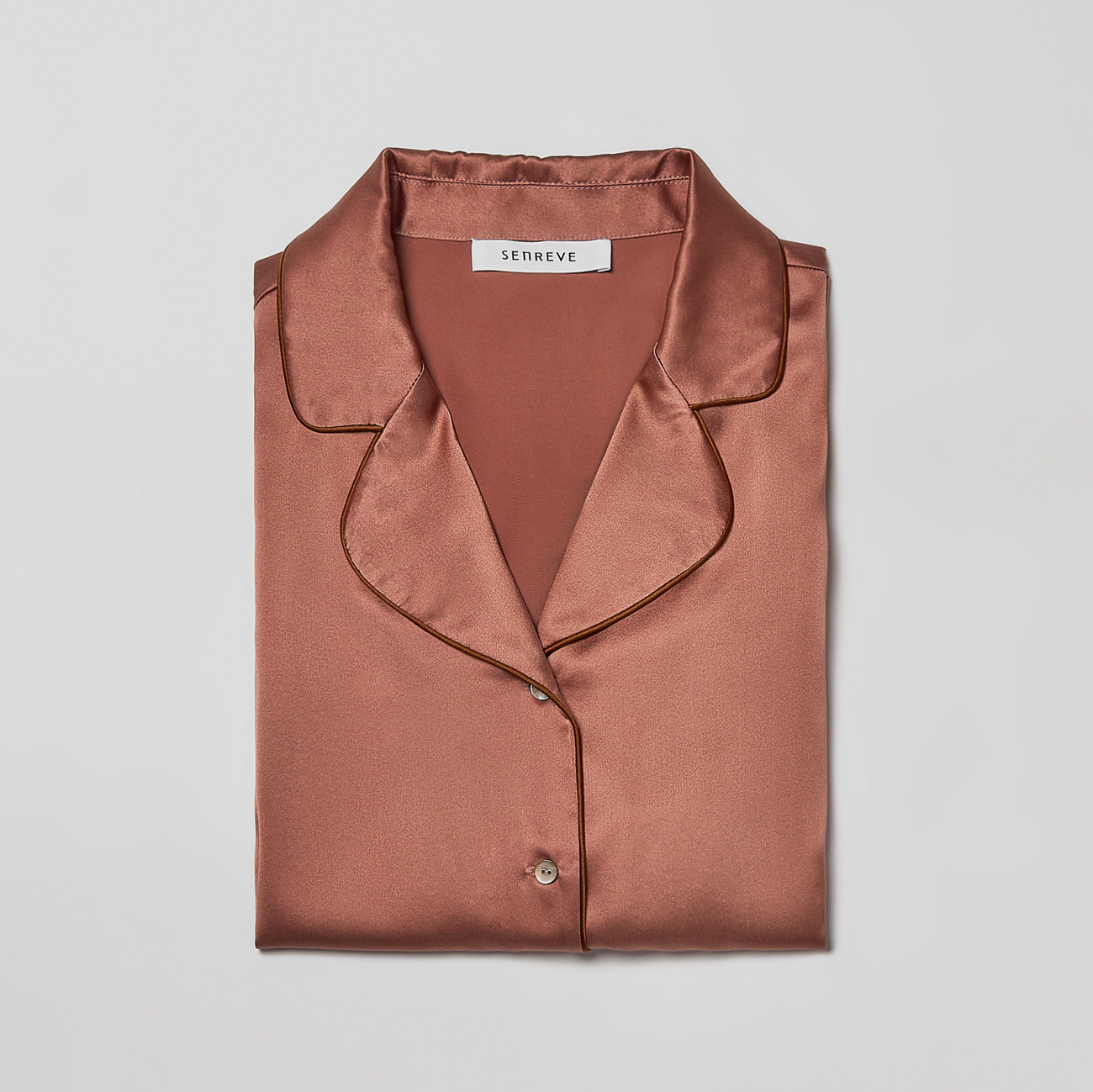 Lumi silk shirt in ash rose folded front view.
