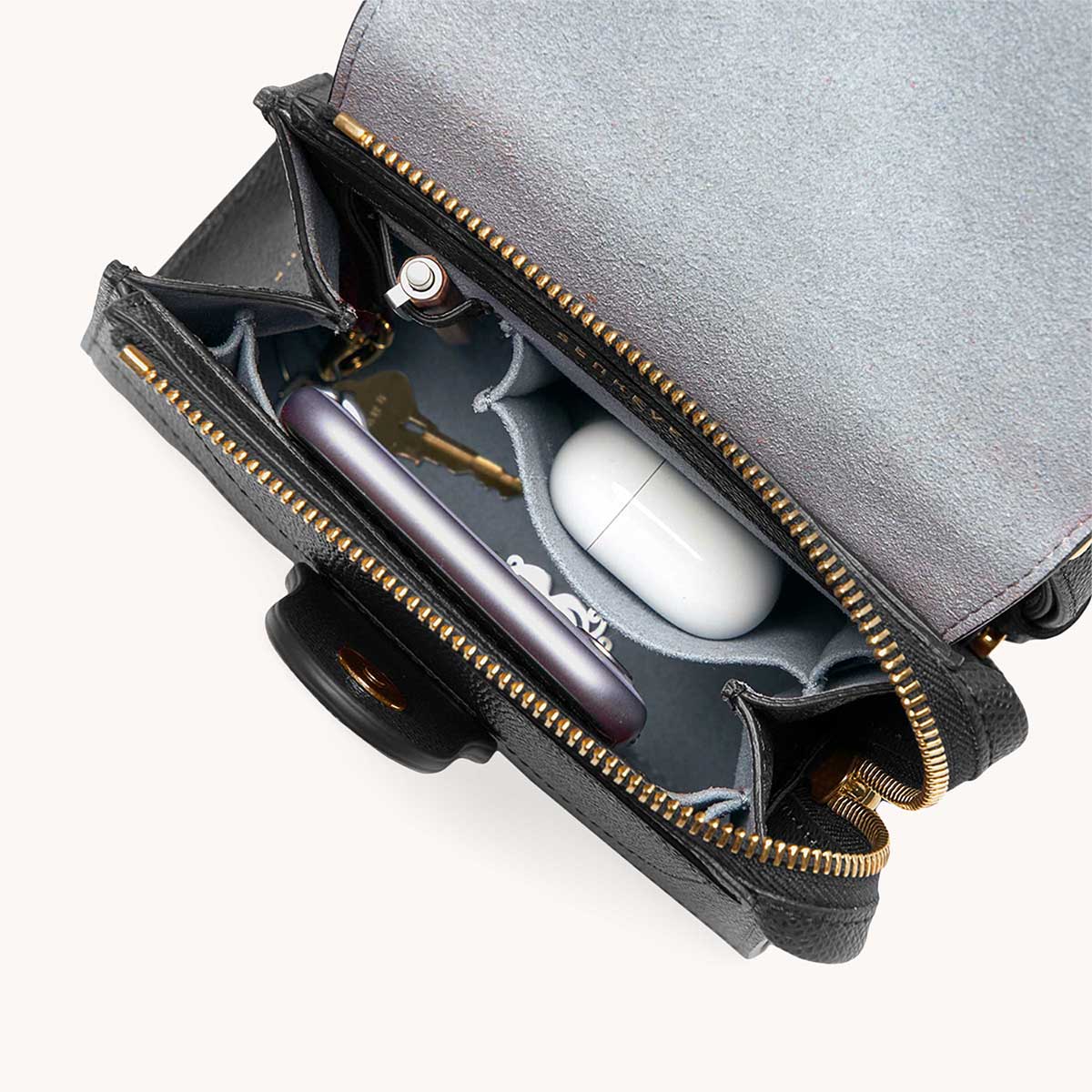 Mini Alunna Bag Pebbled Noir with Gold Hardware Interior View with What Fits: phone, AirPods, keys