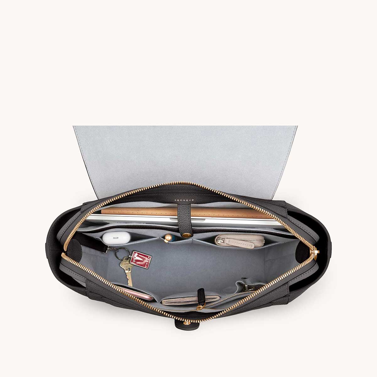 Maestra Bag Dolce Charcoal with Gold Hardware interior with items that fit: AirPods, keys, notebooks, cards, laptop