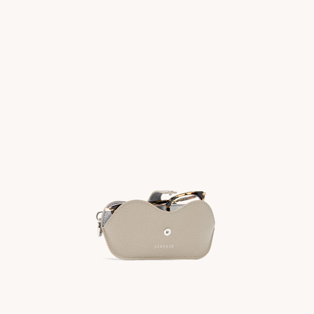 Lunettes case in sand with glasses inside front view.