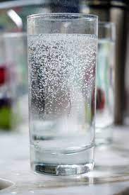 a glass of water with bubbles