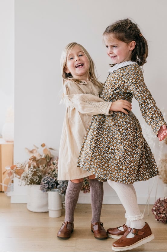 two girls wearing dresses and collégien tights