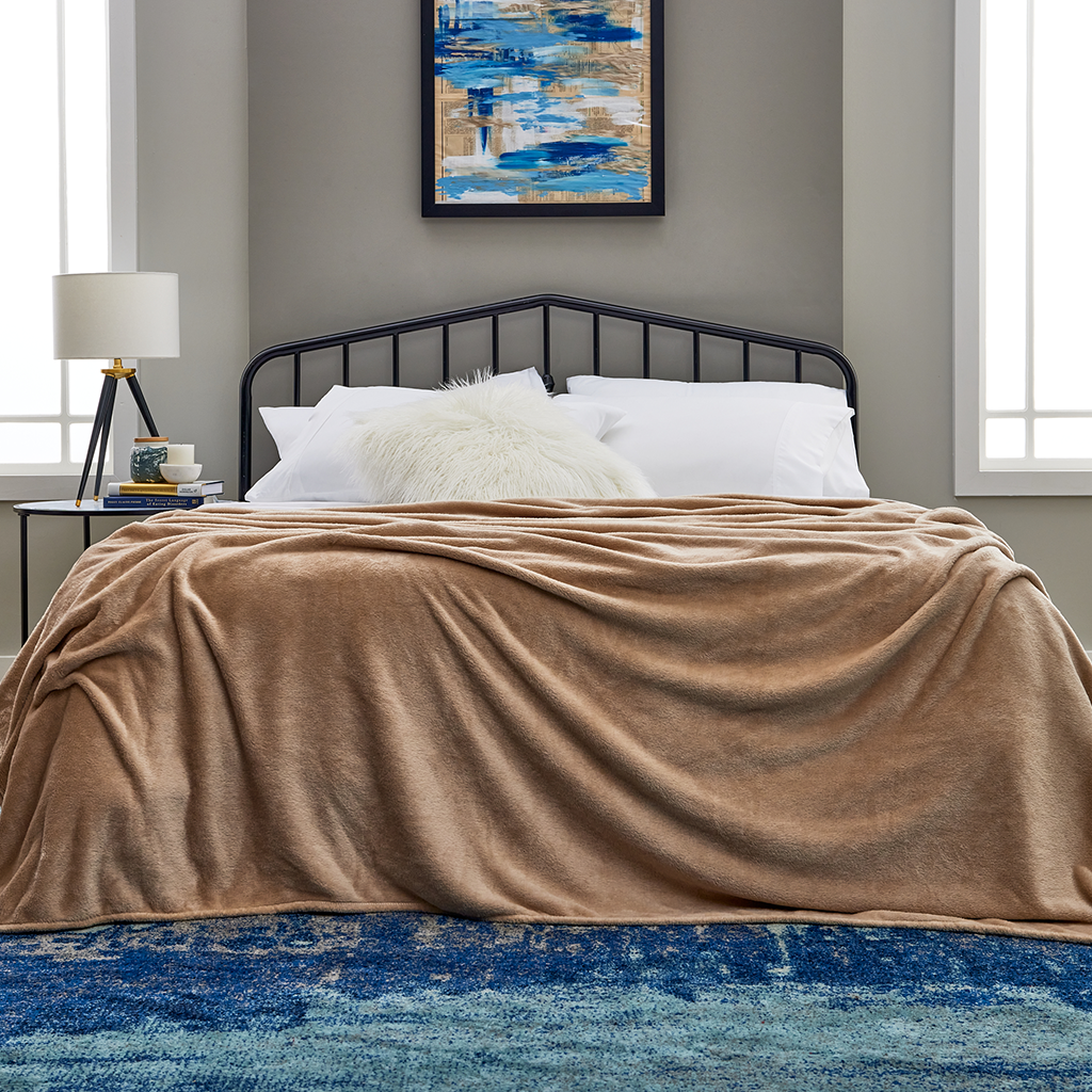A cozy bed dressed in Cosy House Collection bedding.