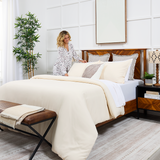 A cozy bed dressed in Cosy House Collection bedding.