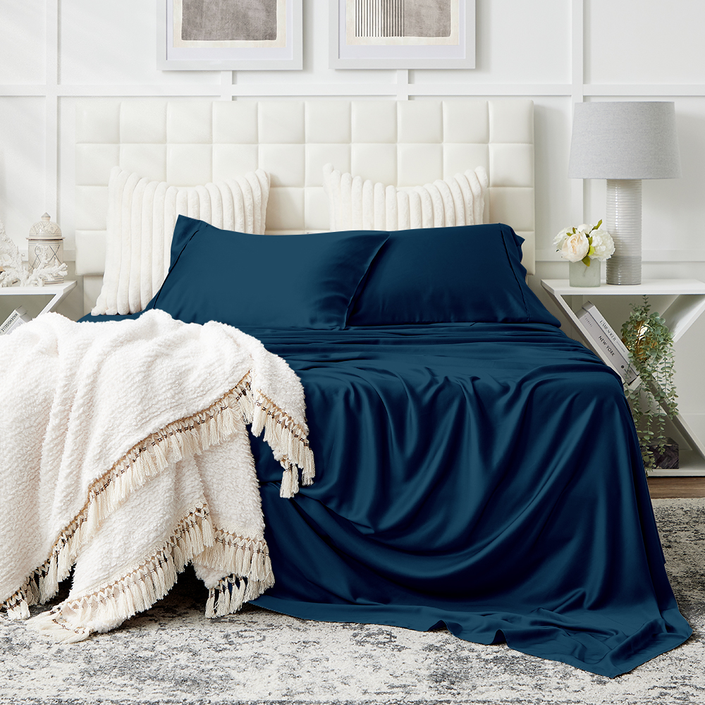 A pristine white bed with Cosy House Collection bedding.