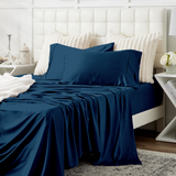 A cozy bed dressed in Cosy House Collection bedding.