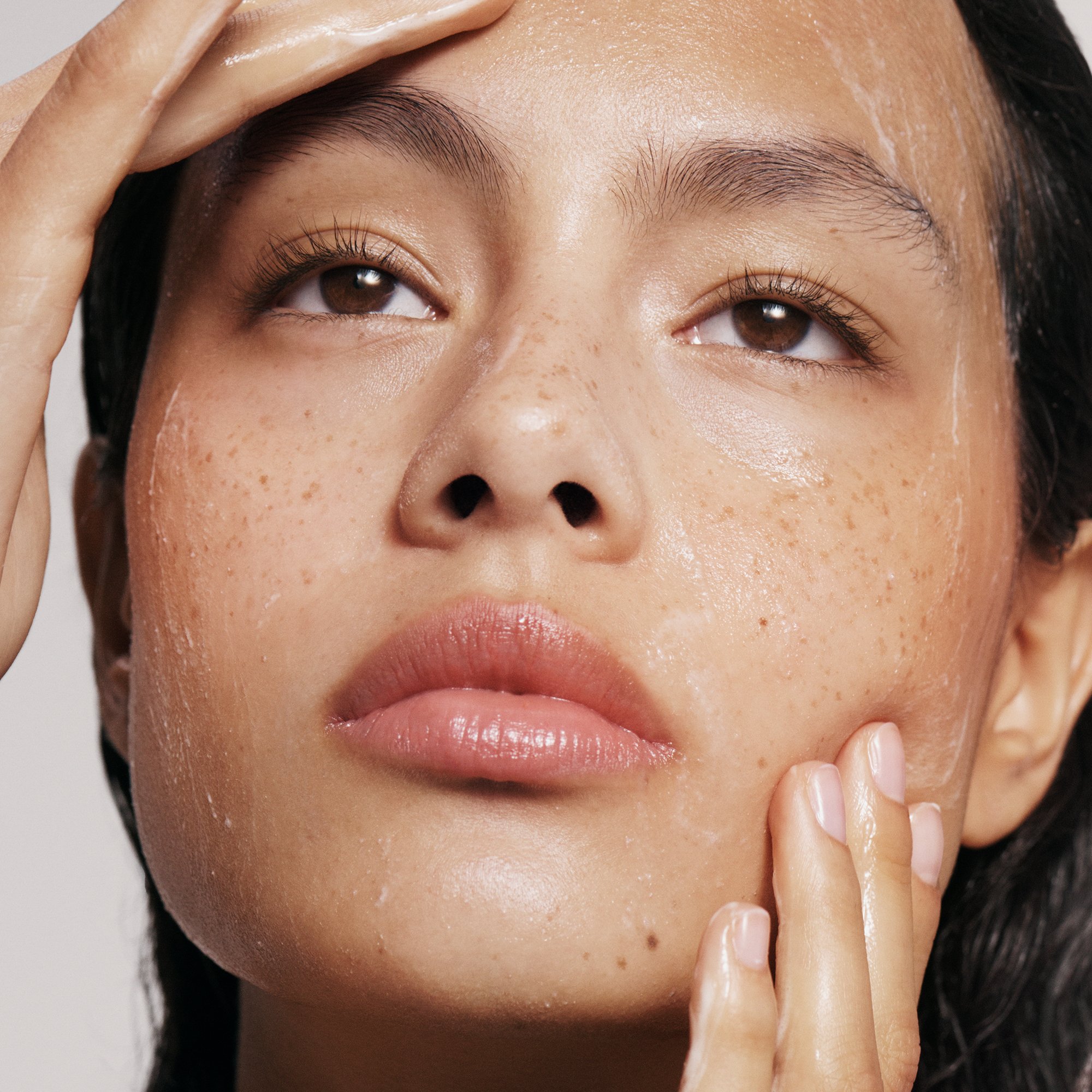 Image of model using the Skin Clarity Gentle Exfoliating Cleanser to cleanse skin