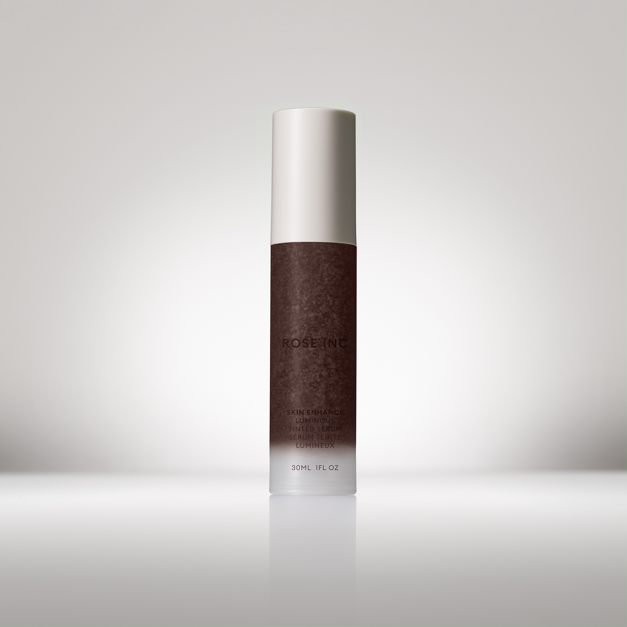 Skin Enhance Luminous Tinted Serum bottle in shade 140 with the cap on.
