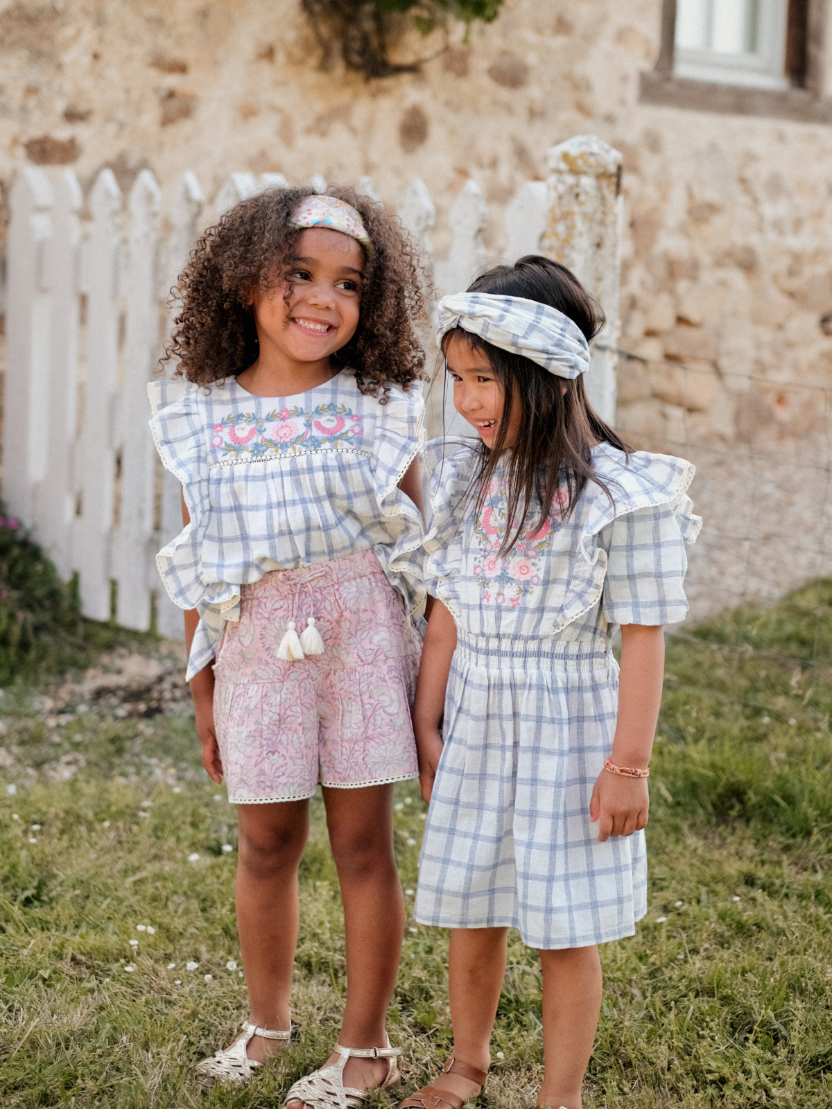 two girls standing in a field