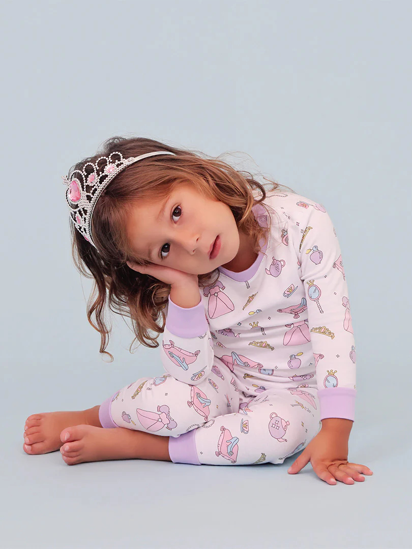 girl wearing pink princess pajamas and a tiara