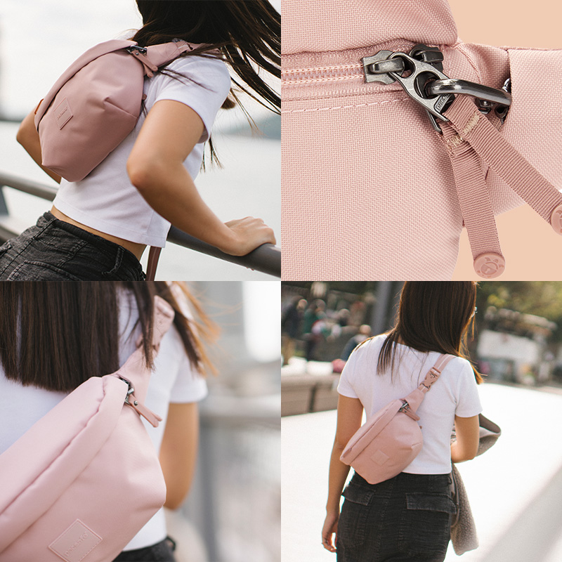 Model wearing the sling pack on her back; Zippers clipped with the zip clip for extra security; Model wearing the sling pack for day trip.