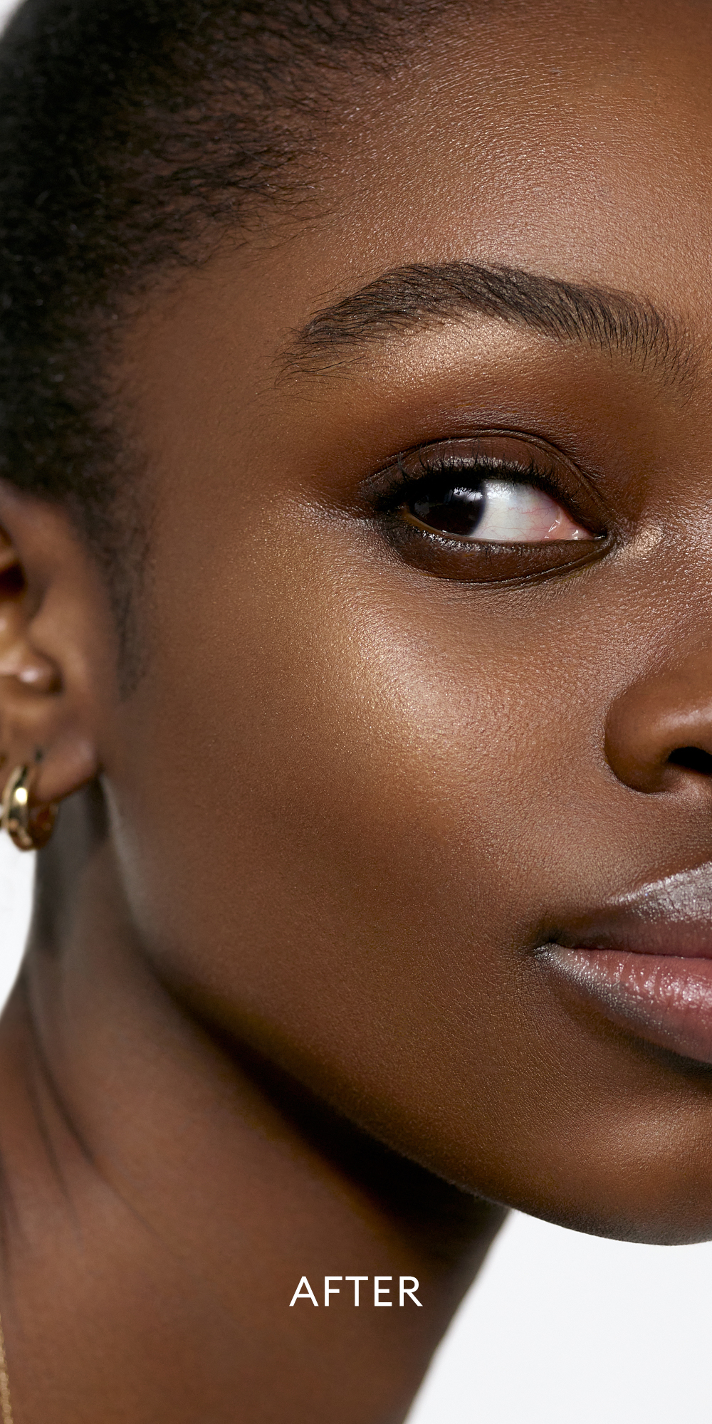 After image of deep skin tone model wearing the Solar Radiance Hydrating Cream Highlight in shade Prismatic 1