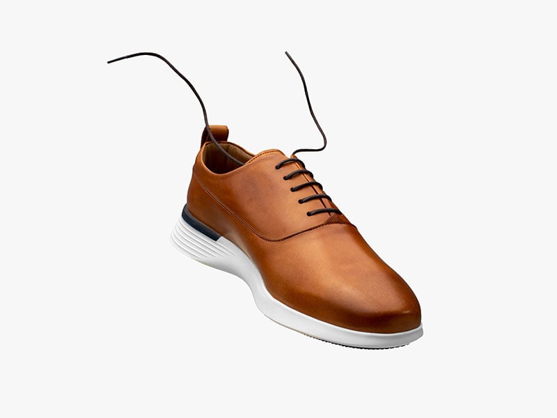 hybrid dress shoe Crossover™ Longwing in Honey floating on a white background