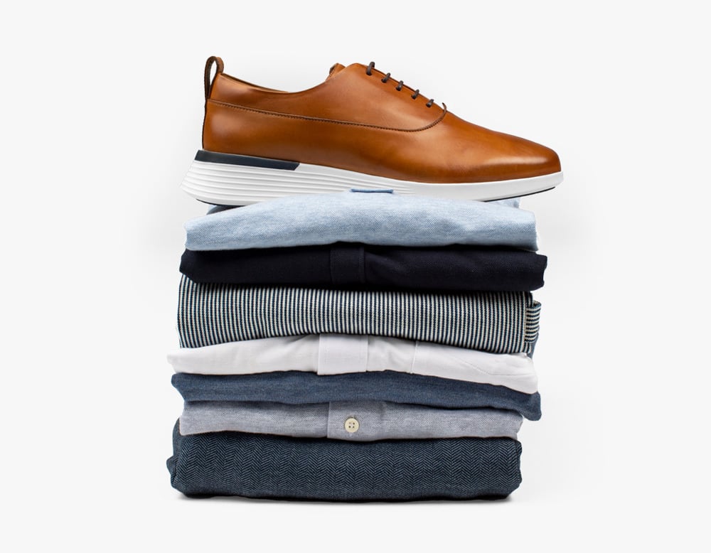 Hybrid dress shoe Crossover™ Longwing in Honey on a stack of folded dress clothes