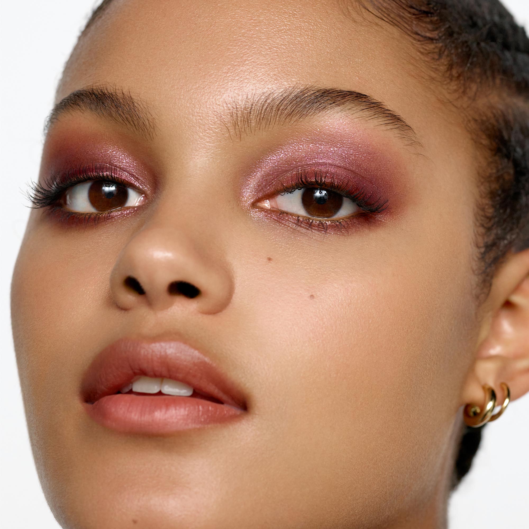 Medium skin tone model wearing the Satin Plum eyeshadow 1