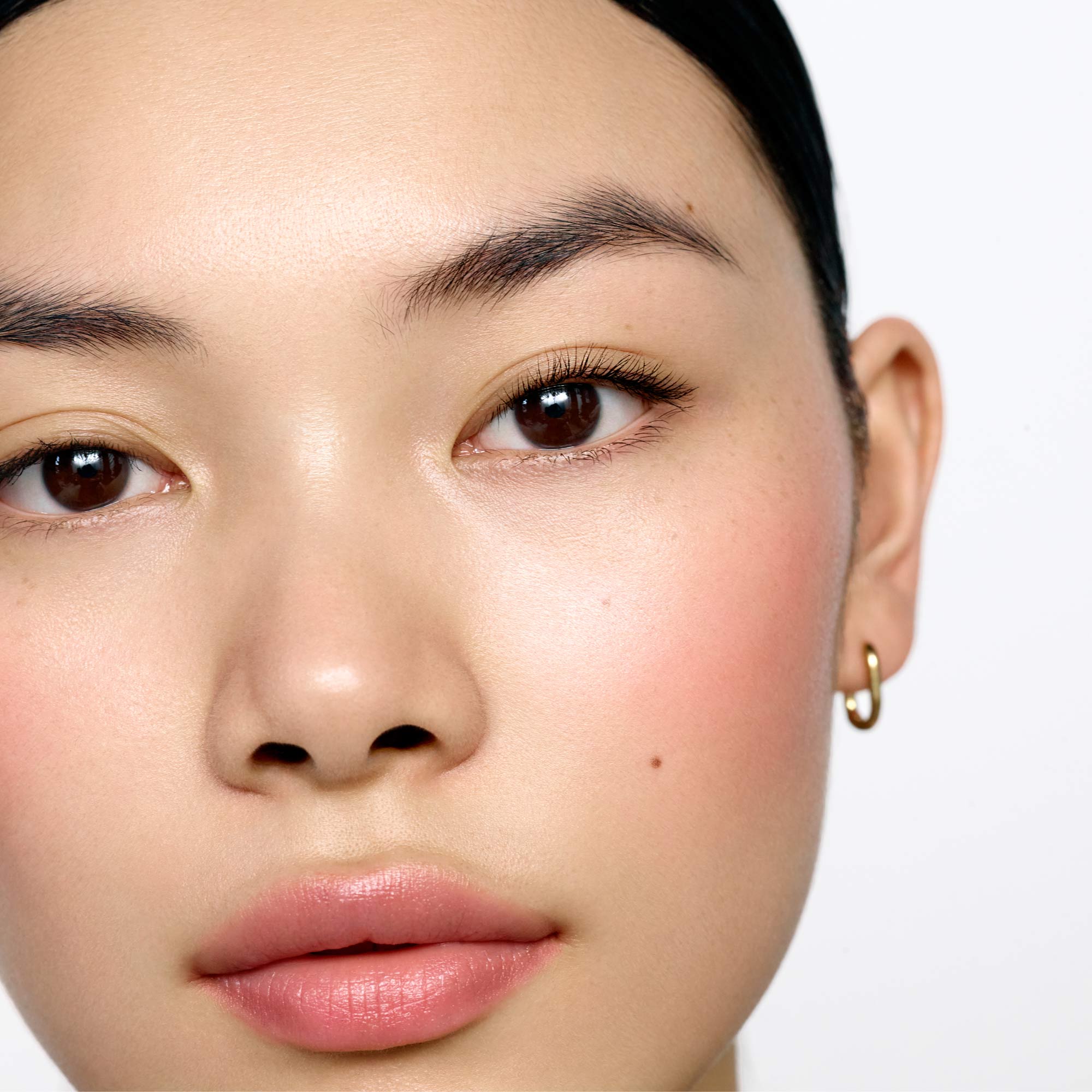 Image of light skin tone model with straight lashes wearing the Ultra Black Lash Lift Serum Mascara