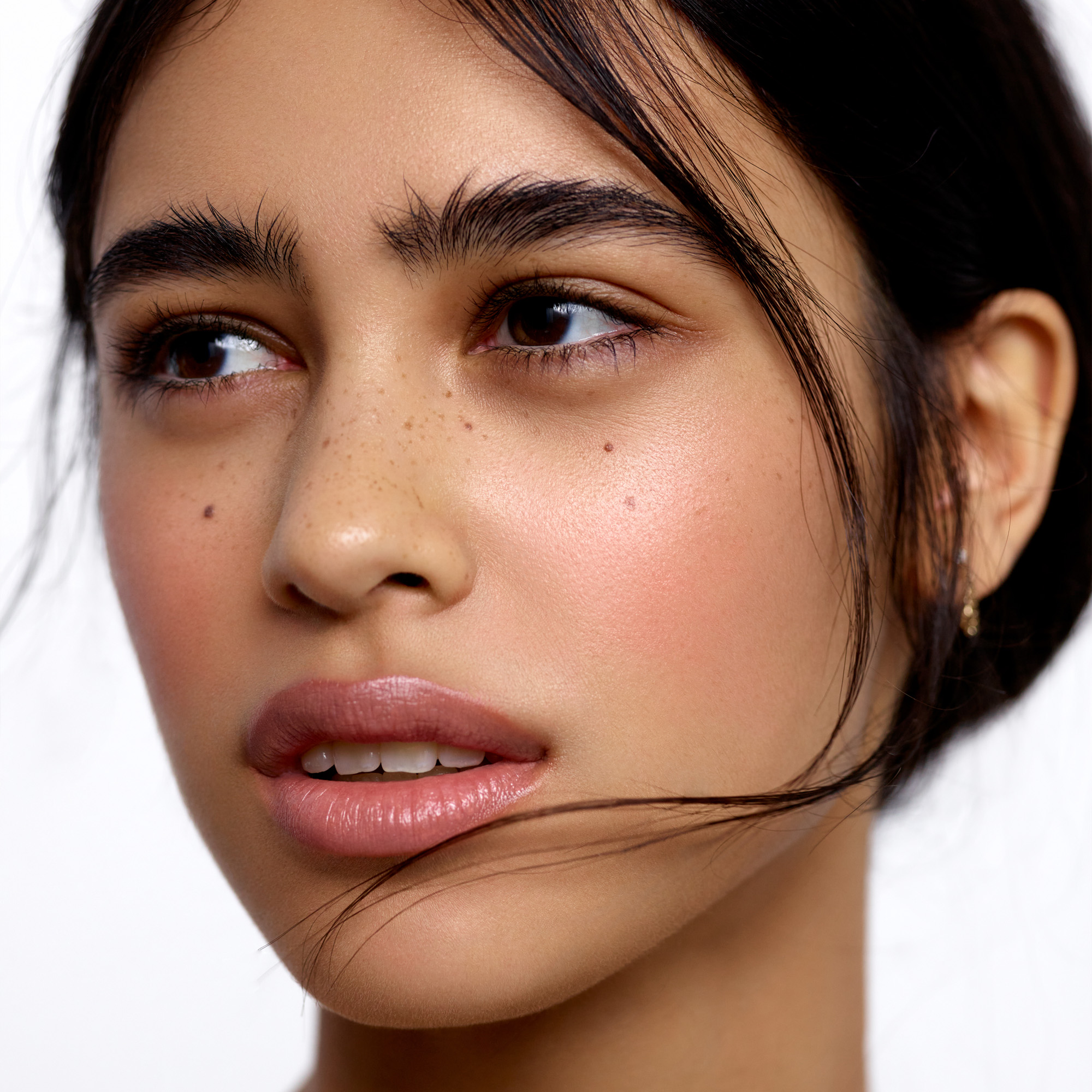 Image of a medium skin tone model wearing the Cream Blush Refillable Cheek & Lip Color in Hydrangea