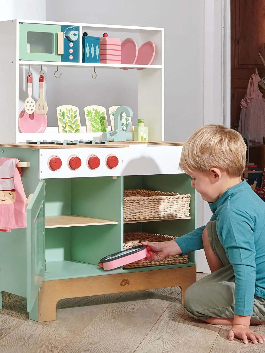 boy playing with tender leaf toys pretend kitchen