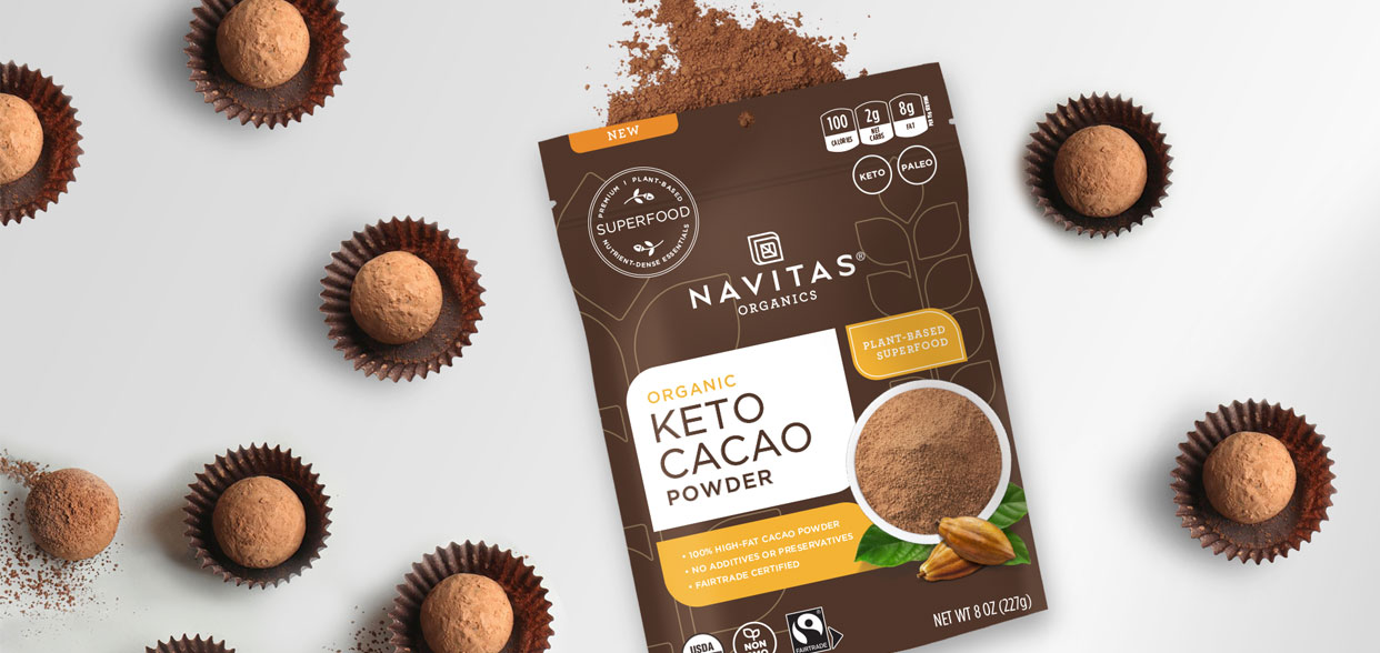 Package of Navitas Keto Cacao Powder surrounded by dessert balls made with Navitas Keto Cacao Powder