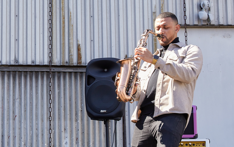 a person playing the e flat alto sax standing