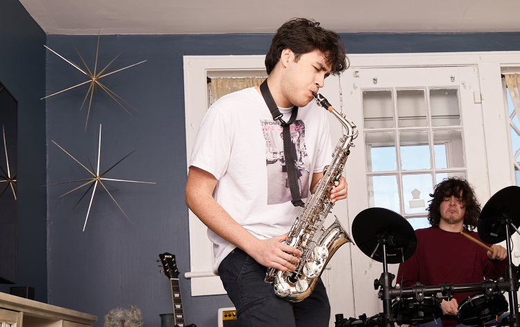 a person playing the e flat alto saxophone standing