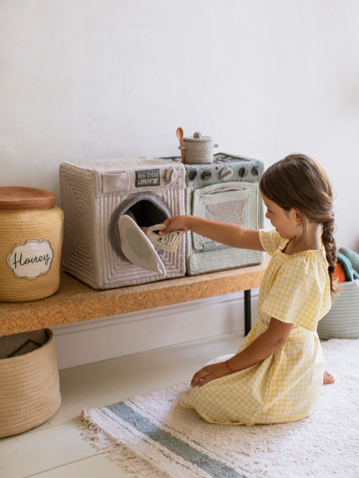 girl playing with laundry basket toy