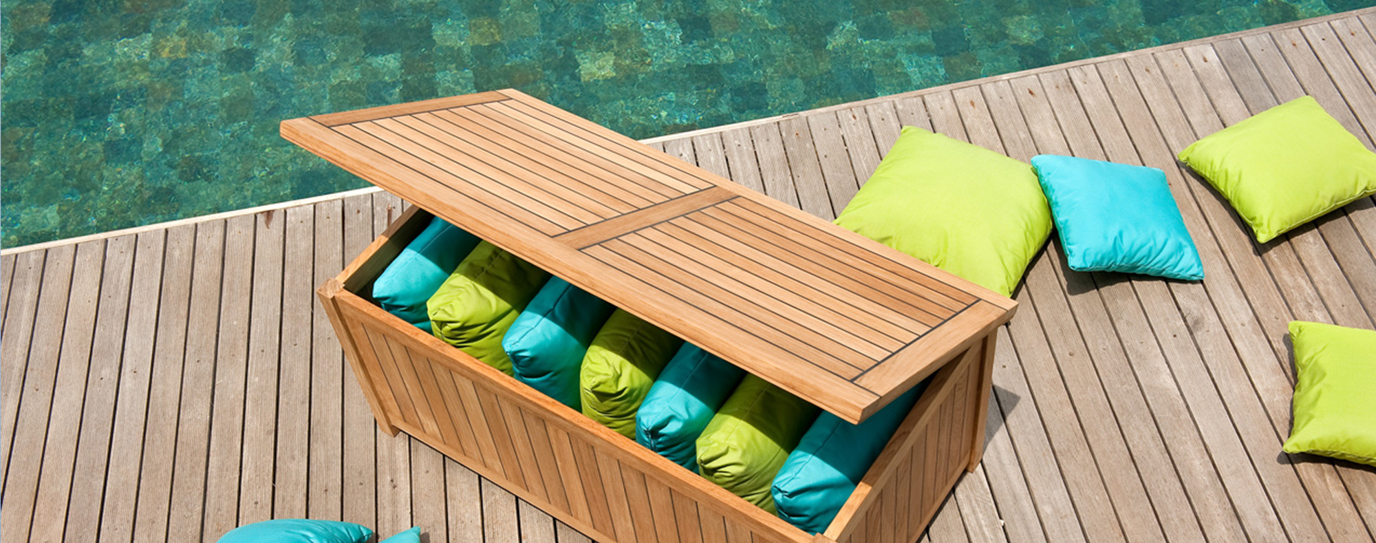 Teak storage box storing outdoor cushions