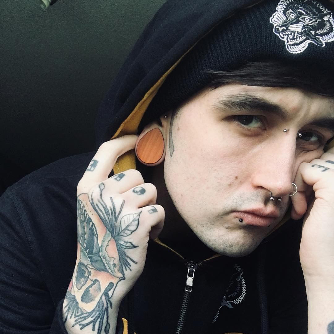 Guy wearing cool Brown Saba Wood Teardrop Wood Ear Plug / Gauge