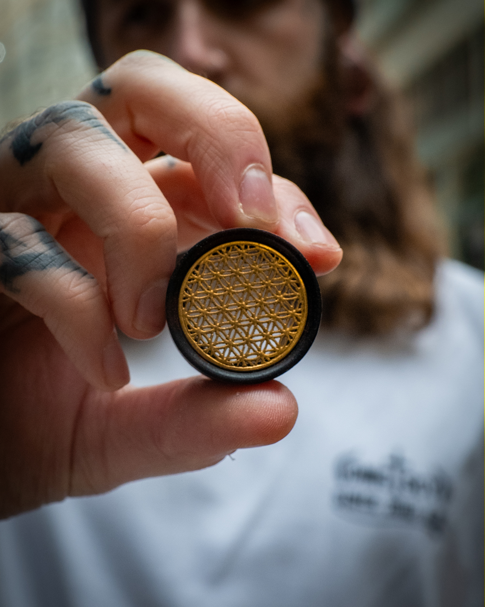 Guy holding big  Brass Flower Of Life  Wood Ear Plug / Gauge