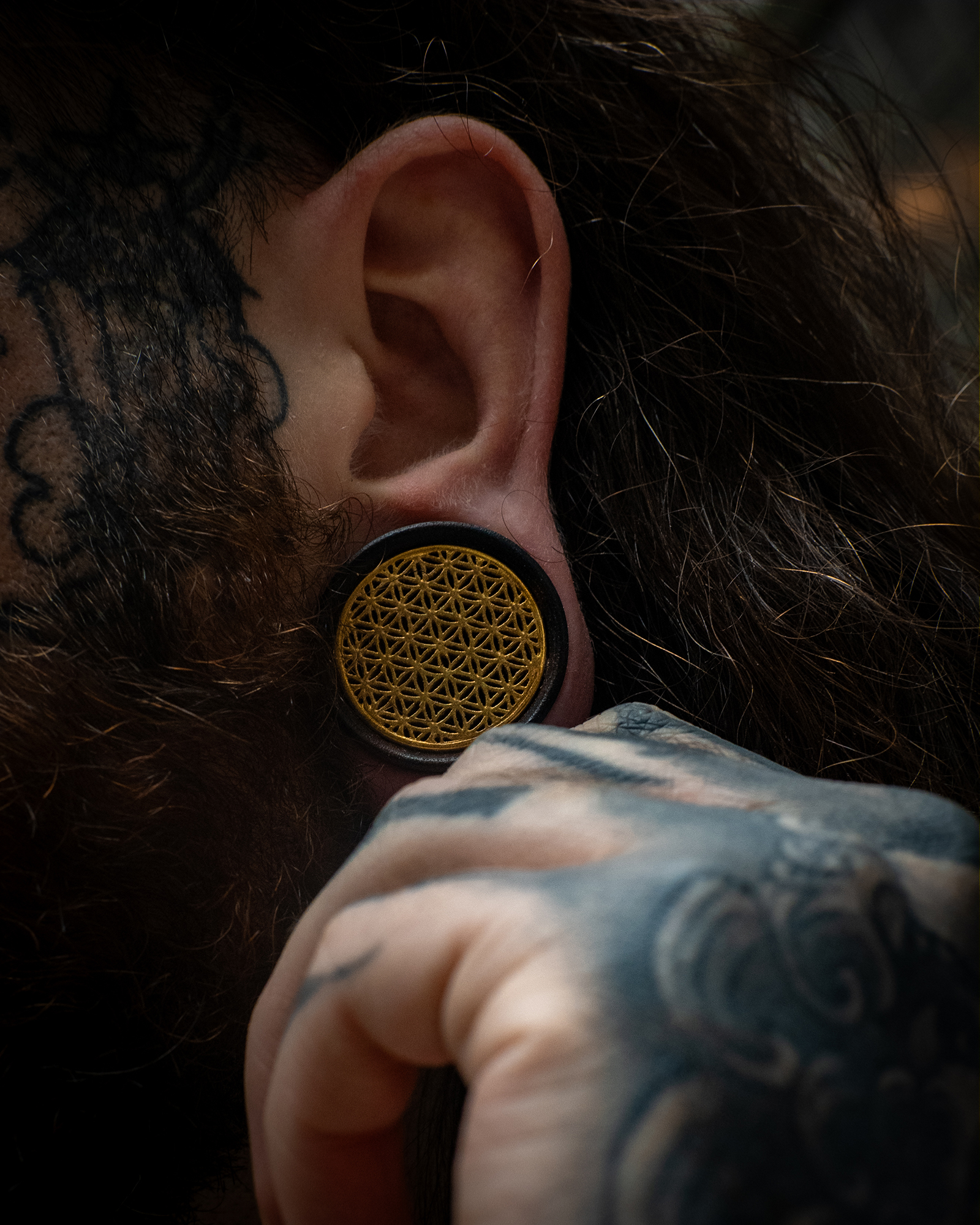 Guy wearing  Brass Flower Of Life  Wood Ear Plug / Gauge