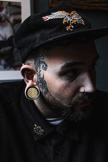 Guy wearing big Brass Flower Of Life  Wood Ear Plug / Gauge