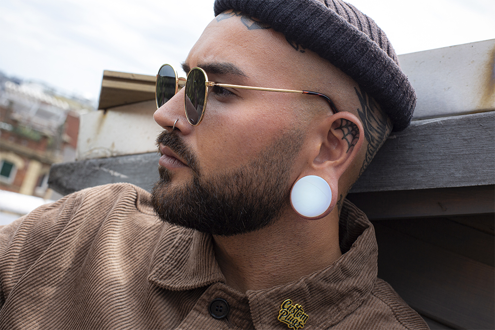 Male wearing large Opalite Glass Plug / Gauge