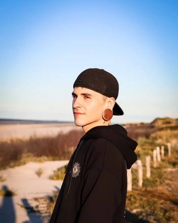 Guy wearing cool Brown Saba Convex Wood Ear Plug / Gauge