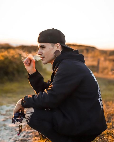 Guy wearing large  Brown Saba Convex Wood Ear Plug / Gauge