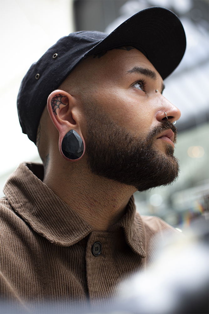 Male wearing large Black Faceted Obsidian Teardrop Glass Plug / Gauge