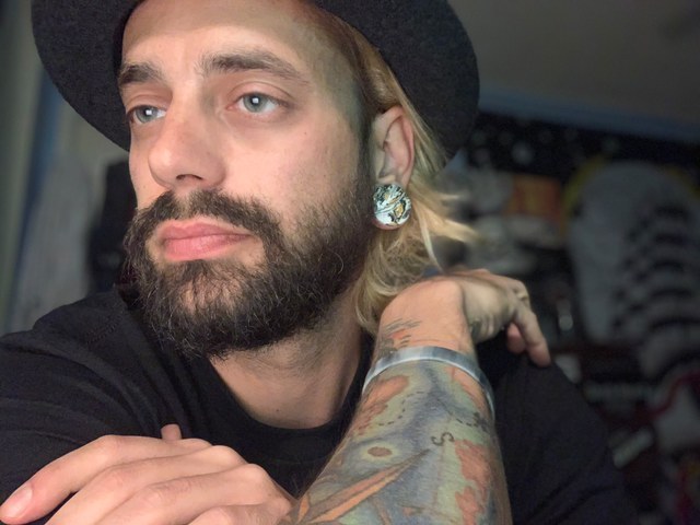 Man wearing unique  Marble Orange & Black Stone Plug / Gauge