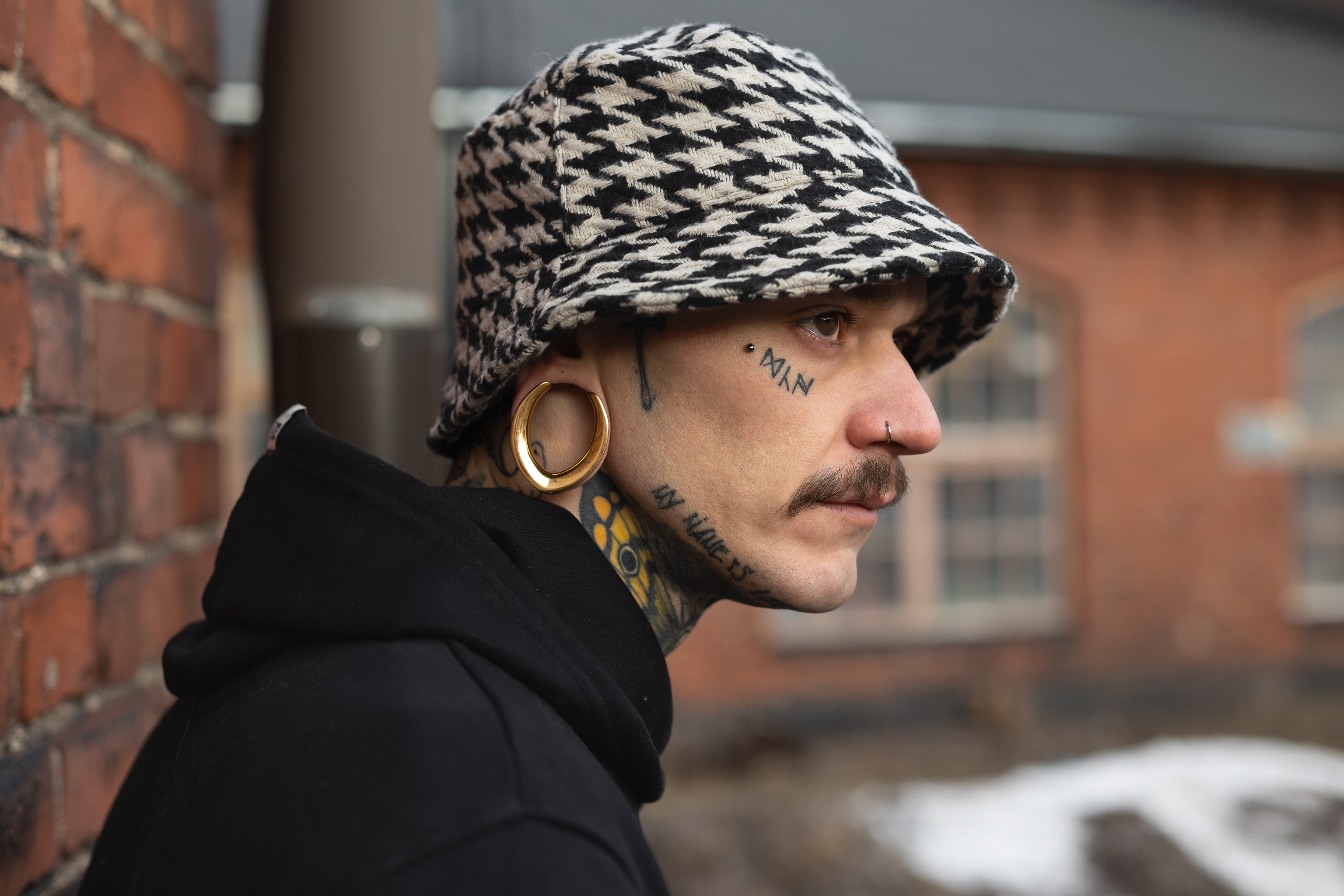 Male wearing large Gold V Saddle Metal Ear Gauge / Plug