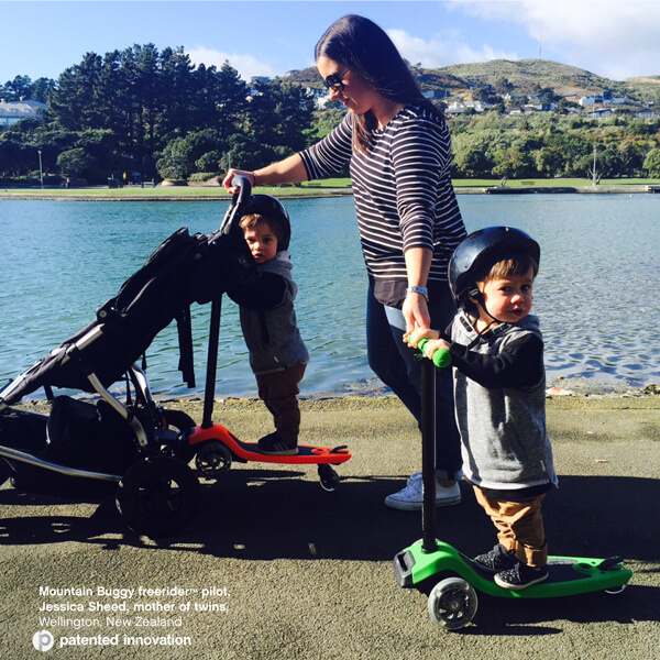 Mum with twin pram with two toddlers riding their scooters - Mountain Buggy freerider™ pilot, Jessica Sheed, mother of twins, New Zealand